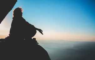 silhouette of a man on a rock